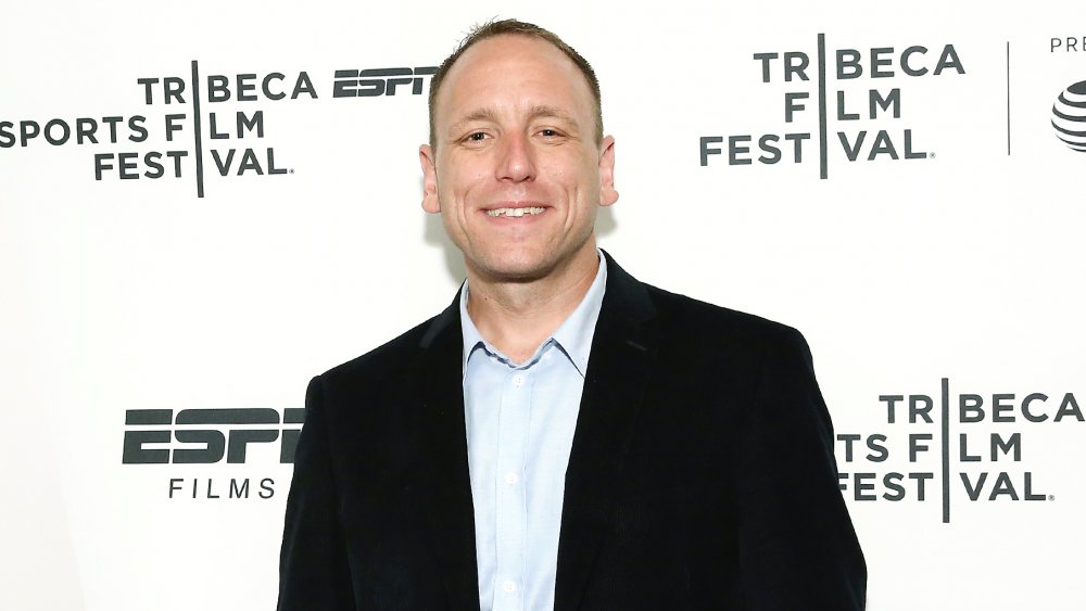 Joey Chestnut smiling and posing on the red carpet