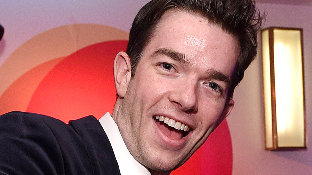 John Mulaney, smiling, mouth open