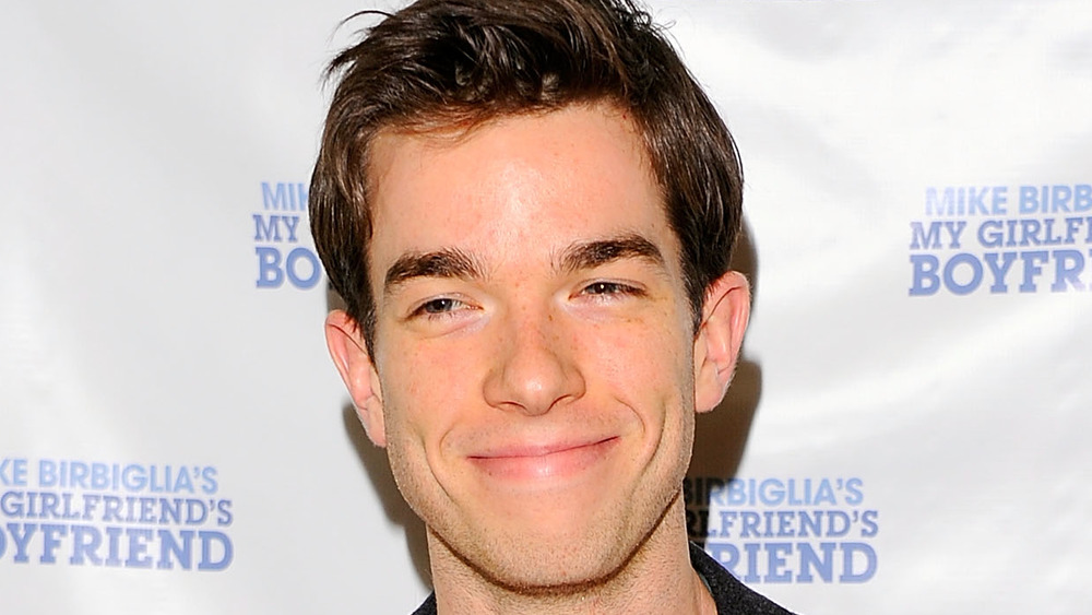 John Mulaney smirking