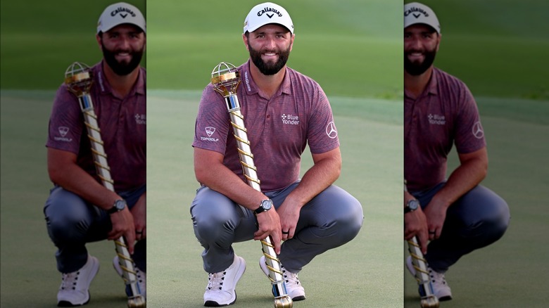 Jon Rahm holding a big trophy