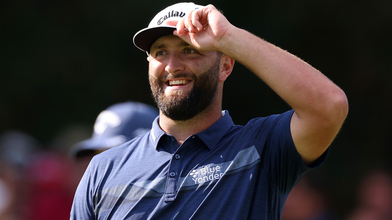 Jon Rahm touching his hat