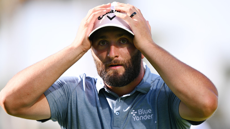 Jon Rahm with his hands on his head