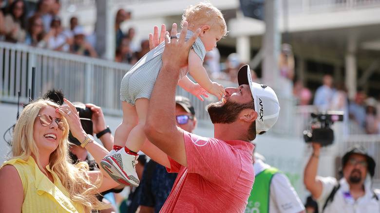 Jon Rahm holding his son Kepa