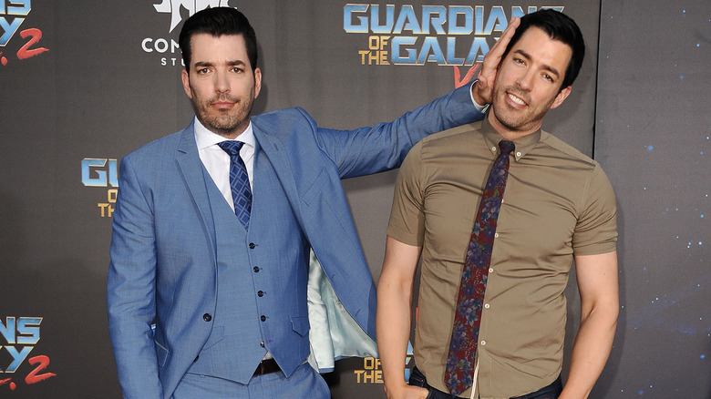 Jonathan and Drew Scott posing at an event