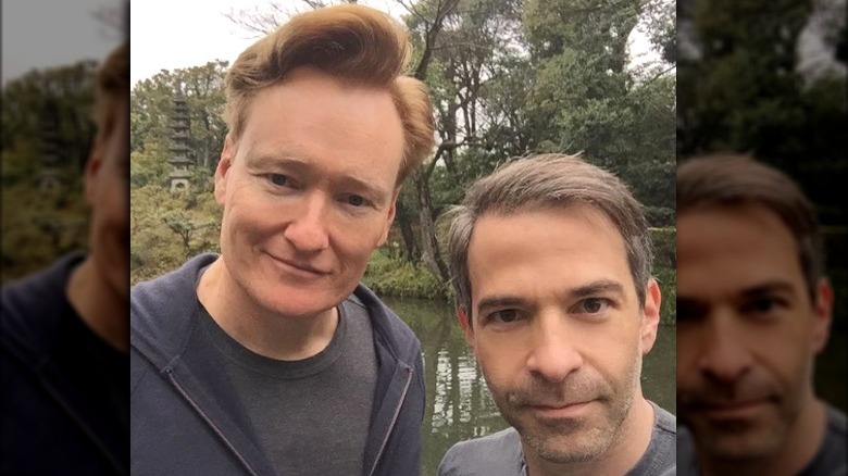 Conan O'Brien smiling with Jordan Schlanksy