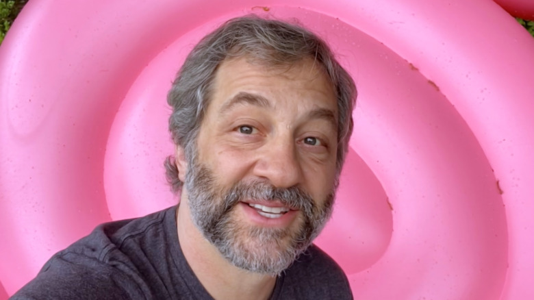 Judd Apatow in front of a pink background