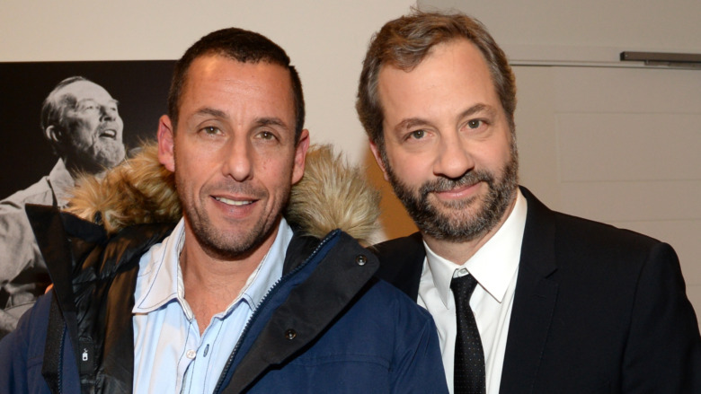 Adam Sandler smiles next to Judd Apatow