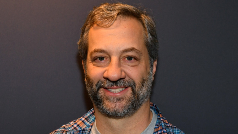 Judd Apatow smiling at a radio studio