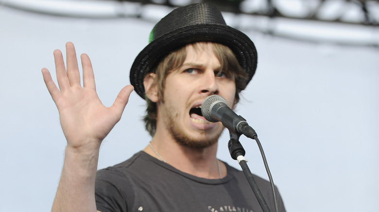 Mark Foster with hand up on stage