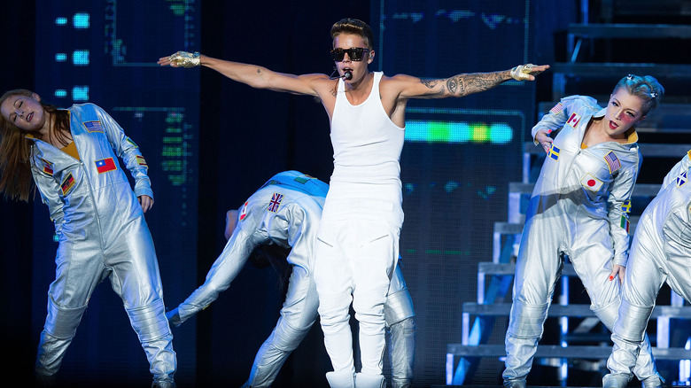 Justin Bieber with dancers onstage