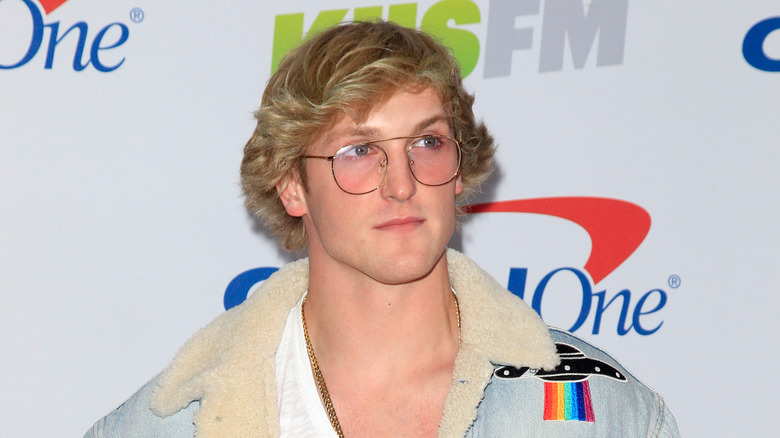 logan paul in pink shades looking up