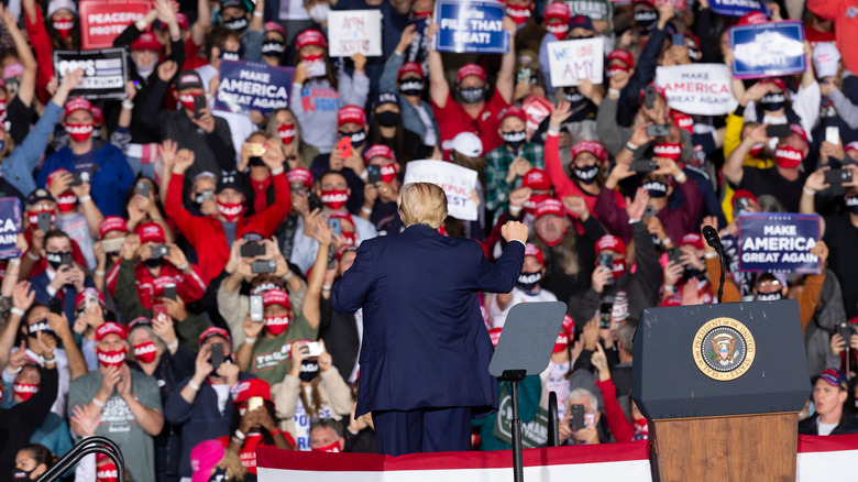 Back of Donald Trump speaking to rally crowd