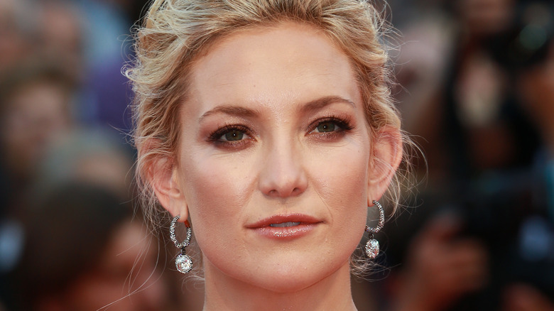 Kate Hudson looks on