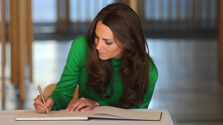Kate Middleton writing green dress