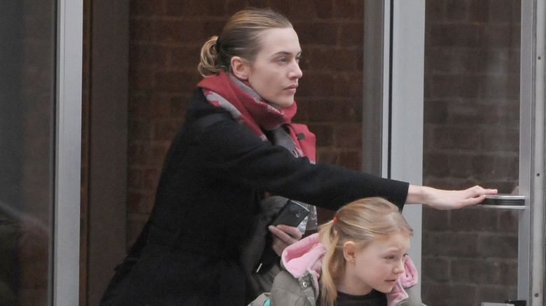 Kate Winslet holding the door for her daughter Mia