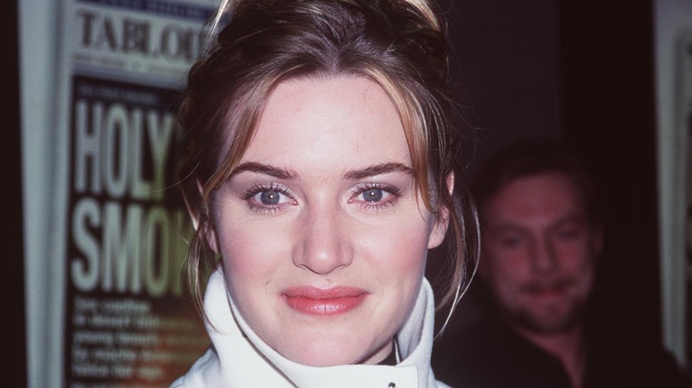 Kate Winslet in a white jacket, posing