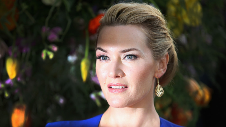 Kate Winslet in front of flowers