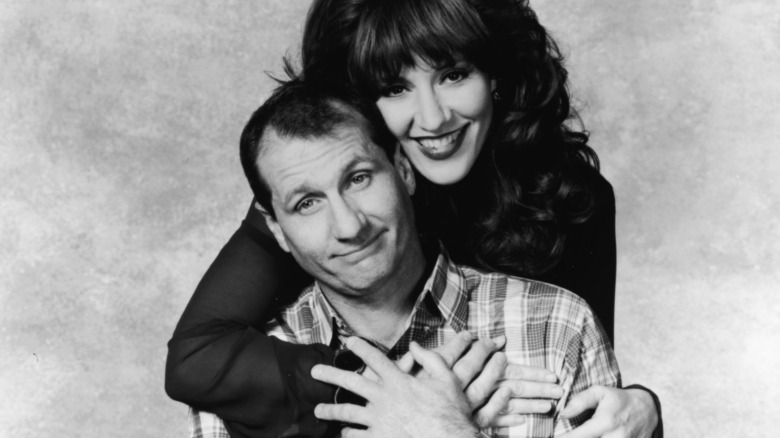 Ed O'Neill and Katey Sagal as Peggy and Al Bundy, posing for a portrait 