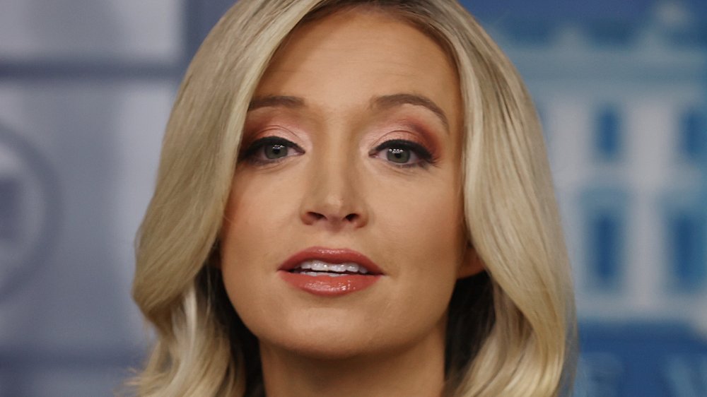 Kayleigh McEnany in a black dress, speaking during a White House press briefing