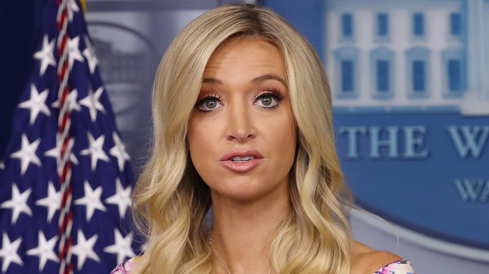 Kayleigh McEnany in a floral dress, speaking during a White House press briefing