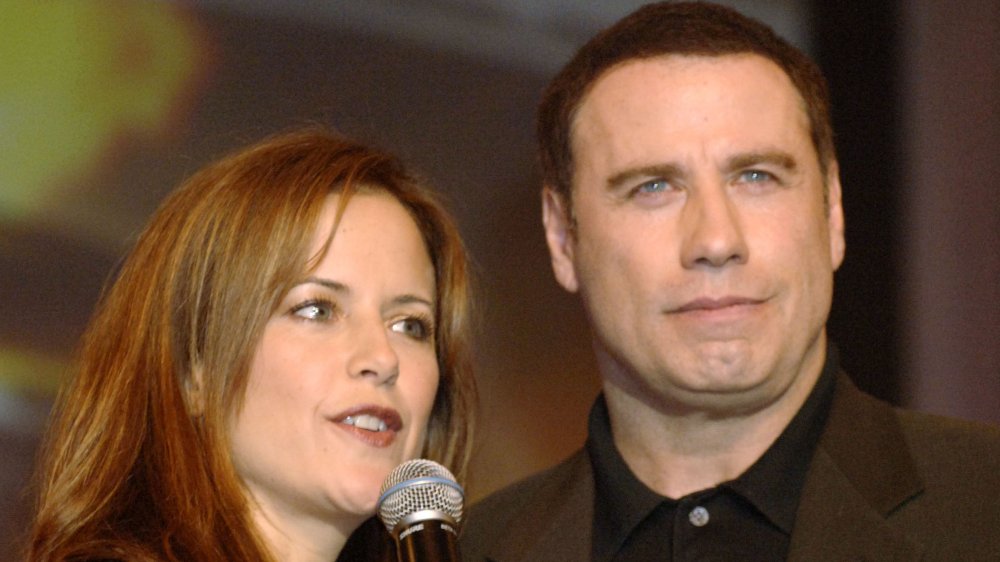 Actors Kelly Preston and husband John Travolta speak on stage during the Church of Scientology Annual Gala charity concert headed by Isaac Hayes, at Saint Hill Manor