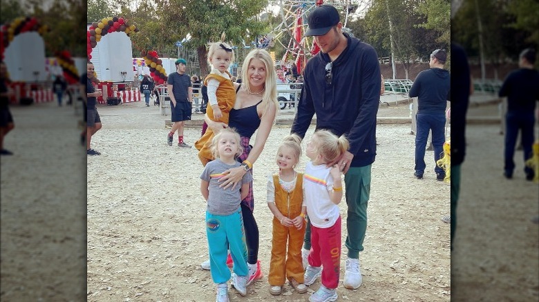 Kelly and Matthew Stafford embracing their four kids