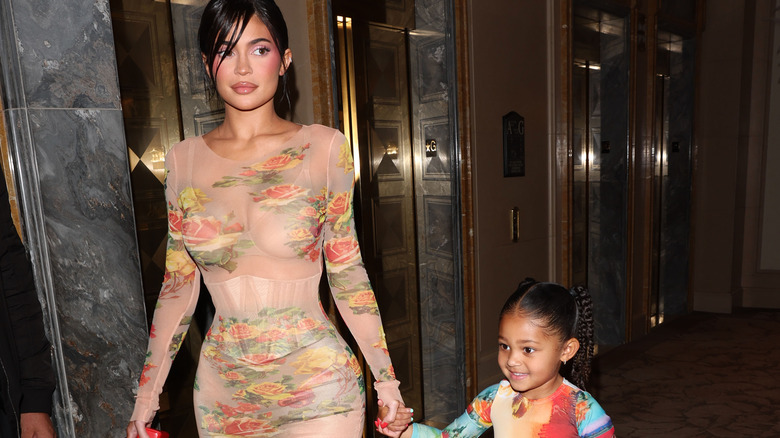 Kylie Jenner and Stormi Webster holding hands, walking