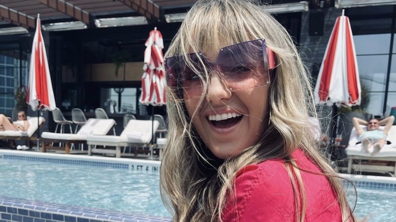 Lainey Wilson smiling by pool