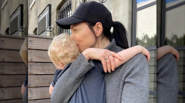 Laura Prepon hugging her son