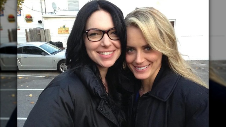 Laura Prepon, Taylor Shilling, smiling on set