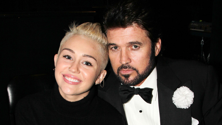 Miley and Billy Ray Cyrus posing