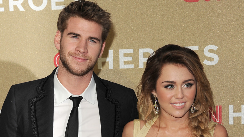 Liam Hemsworth and Miley Cyrus posing