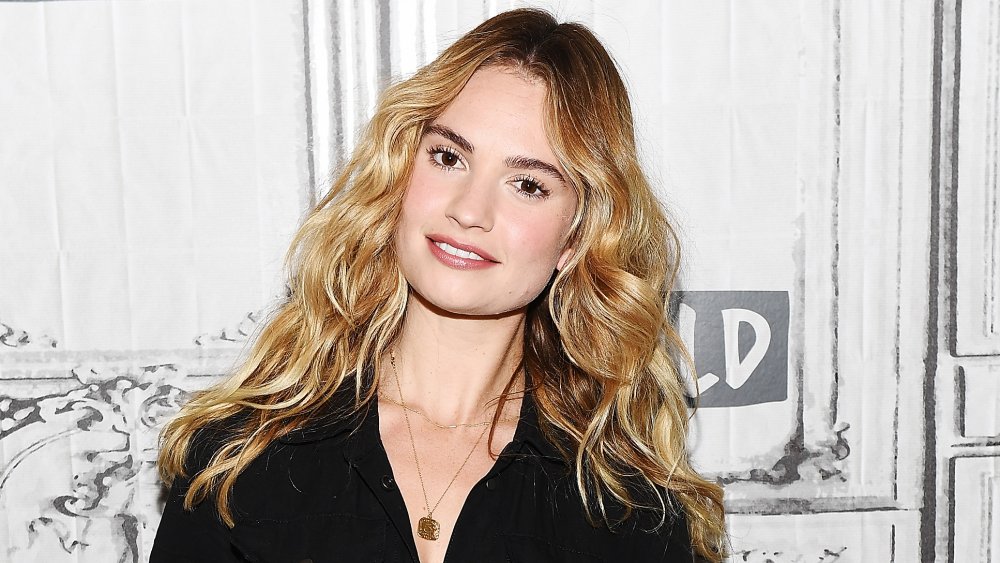 Lily James smiling while tilting her head to the side