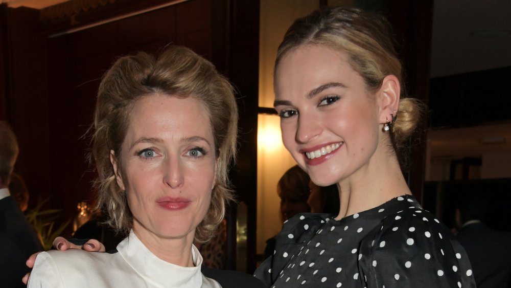 Gillian Anderson and Lily James posing arm in arm