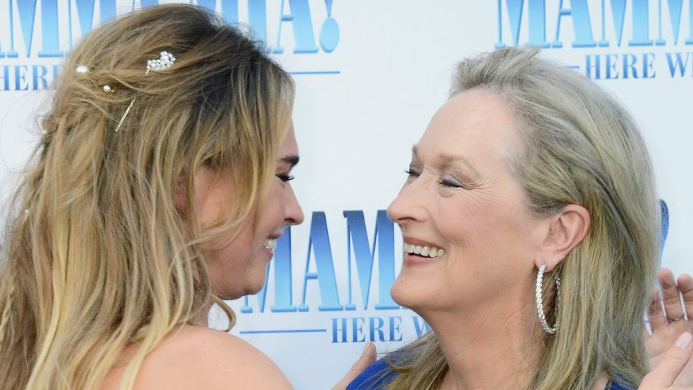 Lily James and Meryl Streep embracing and laughing together