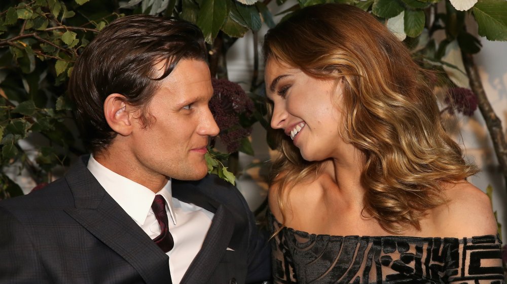 Matt Smith and Lily James smiling while gazing at one another