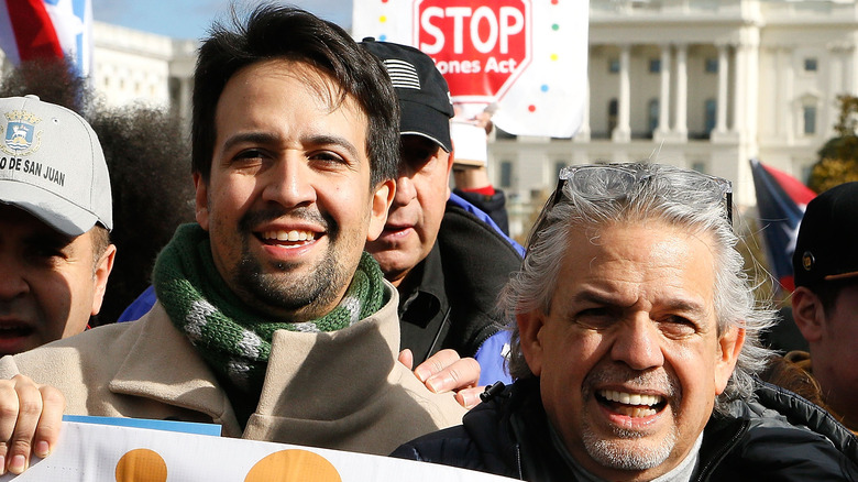  Lin-Manuel Miranda and Luis Miranda marching in Washington D.C.