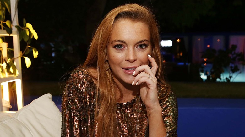 Lindsay Lohan sitting by pool