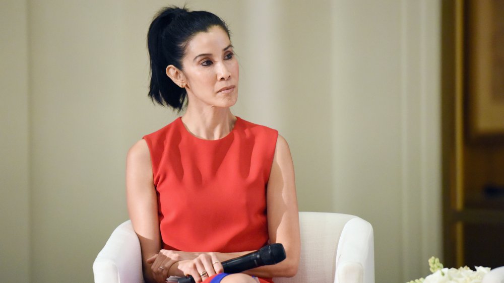 Lisa Ling in a red shirt, microphone in hand