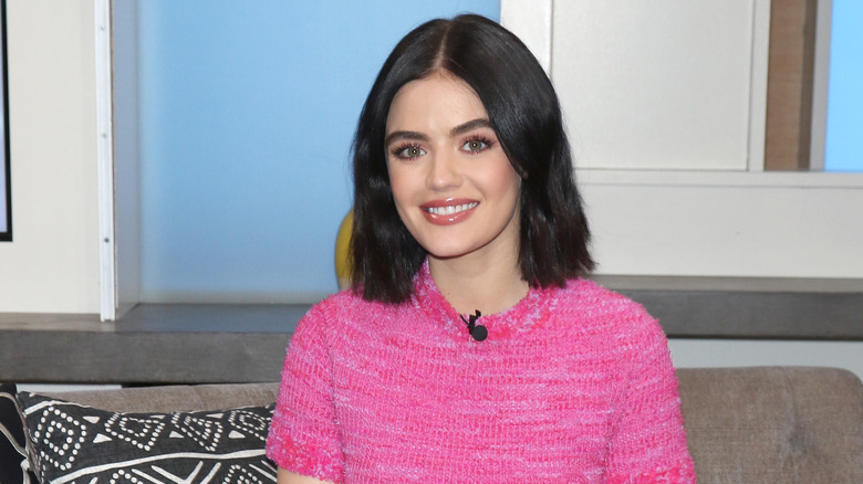 Lucy Hale sitting on a couch