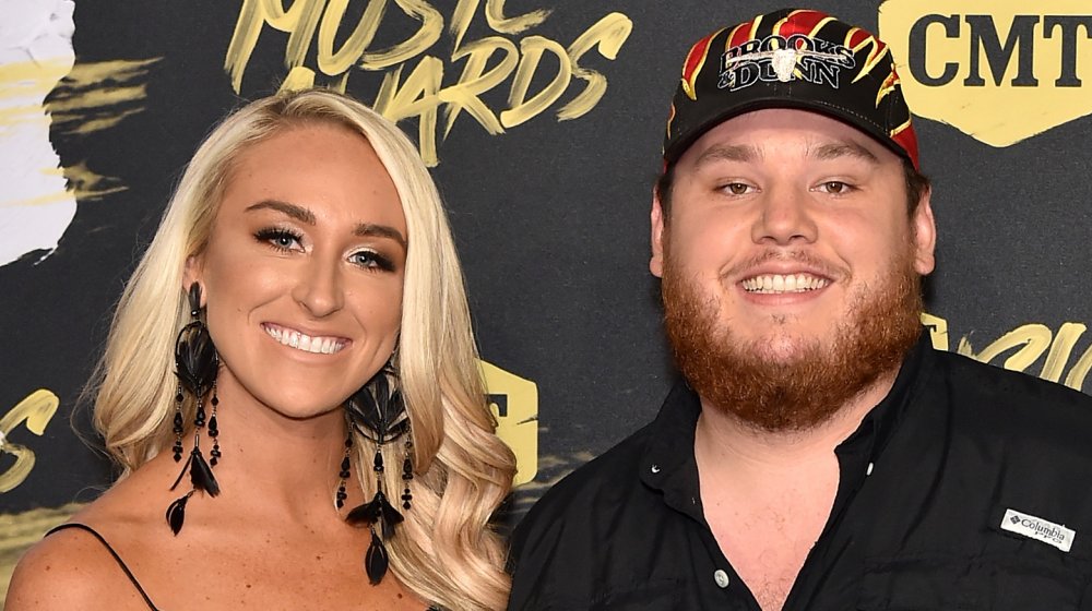 Nicole Hocking and Luke Combs, both wearing black and smiling at the CMT Awards