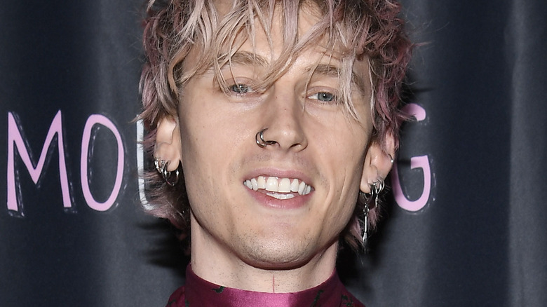 Machine Gun Kelly wearing a pink suit with roses on it