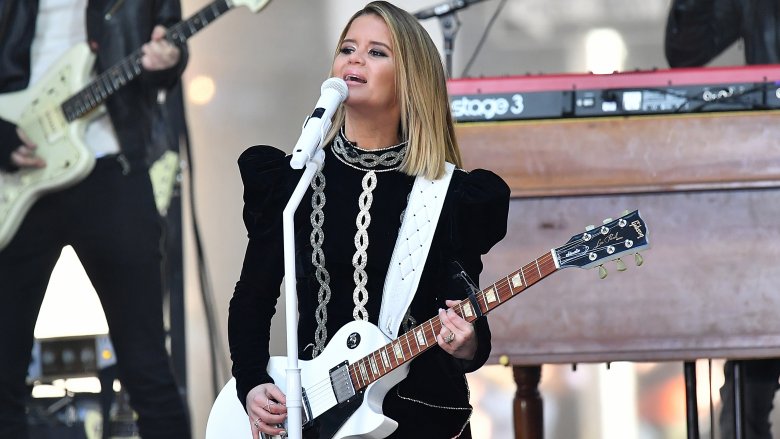 Maren Morris on stage with white guitar