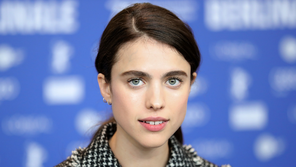 Margaret Qualley with a slight smile 