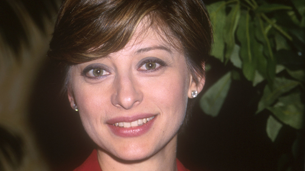 young Maria Bartiromo smiling at camera