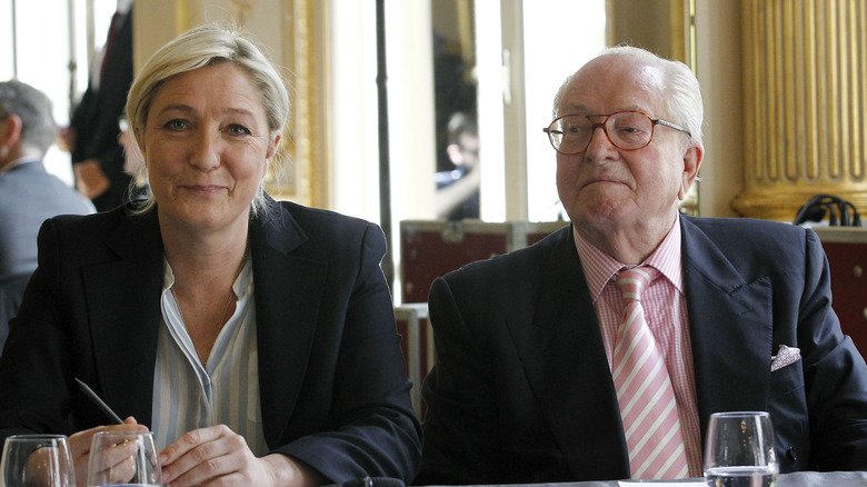 Marine Le Pen and Jean-Marie Le Pen sitting side-by-side