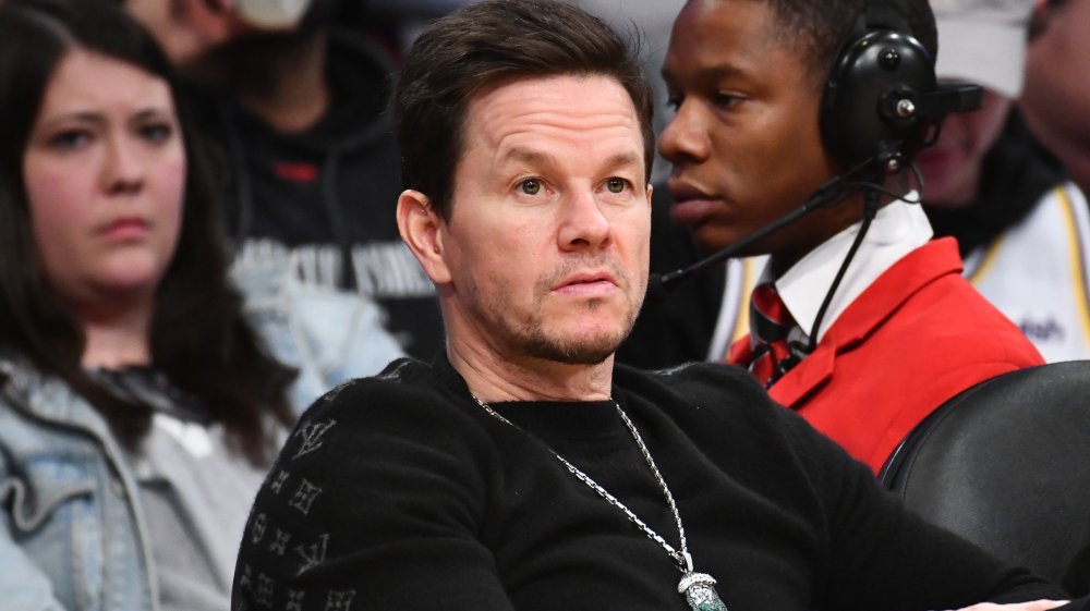 Mark Wahlberg in a black shirt, sitting