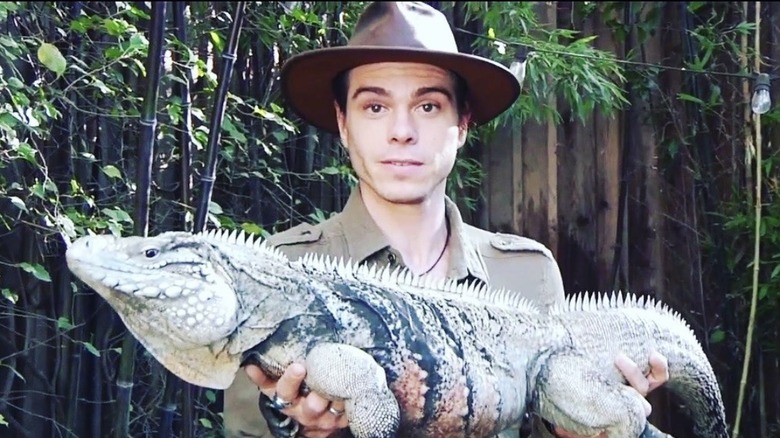 Matthew Lawrence, holding an iguana