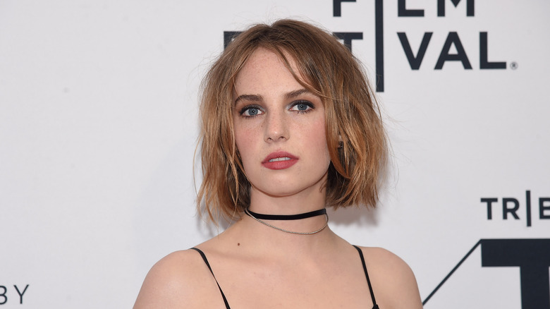 Maya Hawke posing in front of a step and repeat