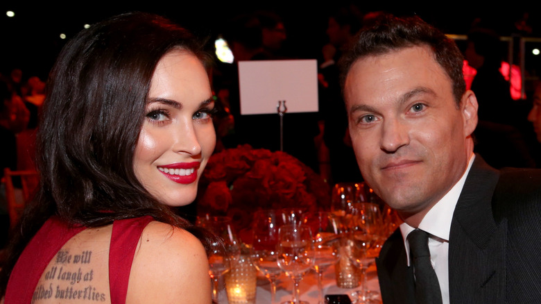 Megan Fox and Brian Austin Green sitting at a table